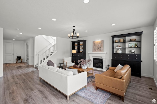 1314 W 1550 N, Lehi, UT 84043 - living area with wood finished floors, a chandelier, recessed lighting, a glass covered fireplace, and stairway
