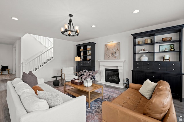1314 W 1550 N, Lehi, UT 84043 - living area with stairs, a chandelier, wood finished floors, recessed lighting, and a glass covered fireplace