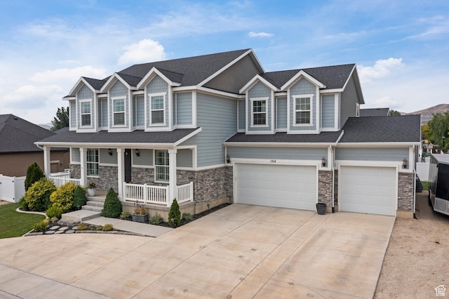 1314 W 1550 N, Lehi, UT 84043 - craftsman-style home featuring covered porch, concrete driveway, stone siding, and an attached garage