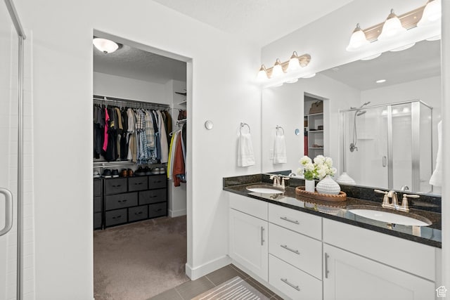 1314 W 1550 N, Lehi, UT 84043 - bathroom with a shower stall, a walk in closet, double vanity, tile patterned floors, and baseboards