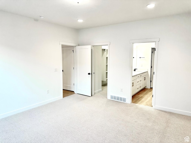 11208 S Easy Bee St Unit 268, South Jordan, UT 84009 - unfurnished bedroom featuring light carpet, baseboards, a walk in closet, recessed lighting, and connected bathroom