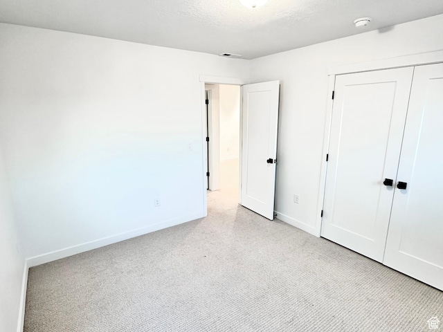 11208 S Easy Bee St Unit 268, South Jordan, UT 84009 - unfurnished bedroom featuring baseboards, a closet, and carpet flooring