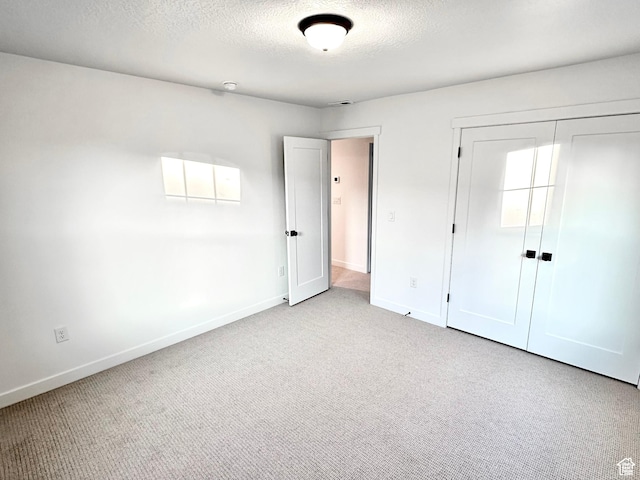 11208 S Easy Bee St Unit 268, South Jordan, UT 84009 - unfurnished bedroom with baseboards, carpet floors, a closet, and a textured ceiling