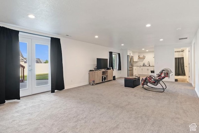 3972 S Lake Vista Dr, Saratoga Springs, UT 84045 - living room with light carpet, plenty of natural light, recessed lighting, and french doors