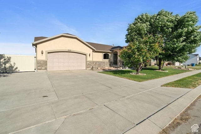3972 S Lake Vista Dr, Saratoga Springs, UT 84045 - view of front facade featuring a garage, stucco siding, driveway, and stone siding