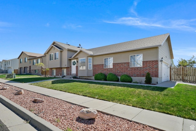 593 N 680 W, Tooele, UT 84074 - view of front of property with brick siding, an attached garage, a residential view, and roof with shingles