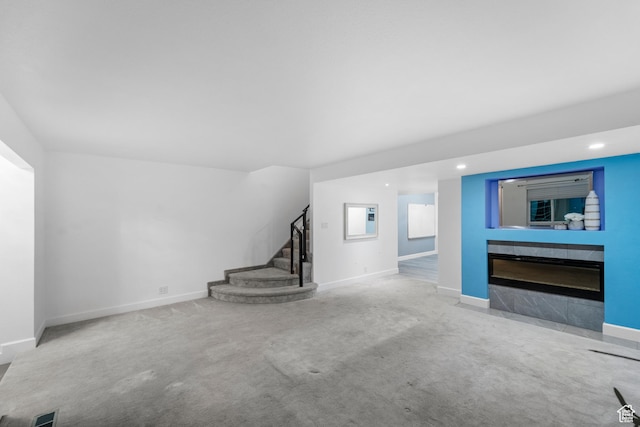 42 Benchmark Vlg, Tooele, UT 84074 - unfurnished living room with stairway, carpet, baseboards, a tiled fireplace, and recessed lighting