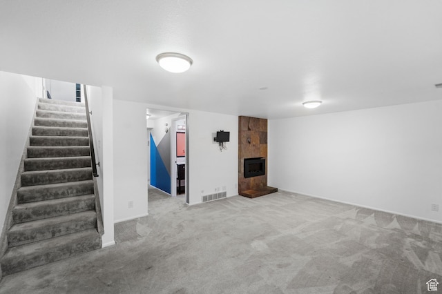 42 Benchmark Vlg, Tooele, UT 84074 - finished below grade area with stairway, carpet floors, a tile fireplace, and baseboards