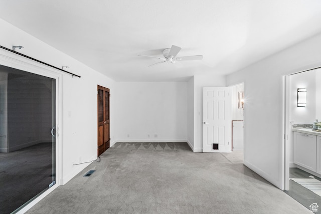 42 Benchmark Vlg, Tooele, UT 84074 - unfurnished bedroom featuring light carpet, baseboards, connected bathroom, and a ceiling fan
