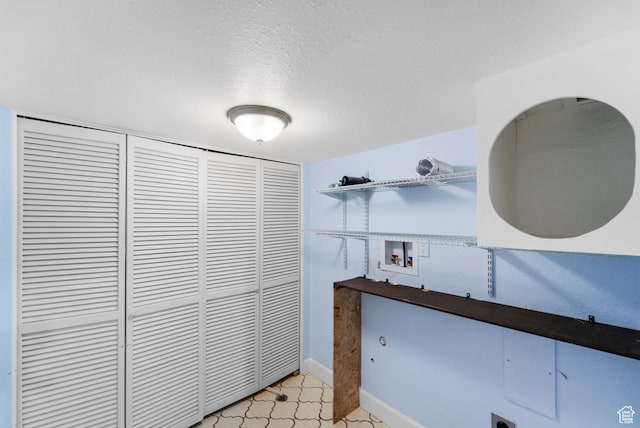 42 Benchmark Vlg, Tooele, UT 84074 - laundry view of a textured ceiling and baseboards
