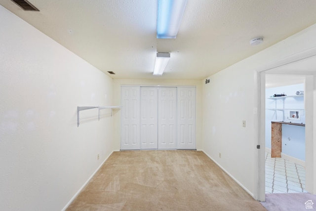 42 Benchmark Vlg, Tooele, UT 84074 - unfurnished bedroom with carpet flooring, baseboards, and a closet