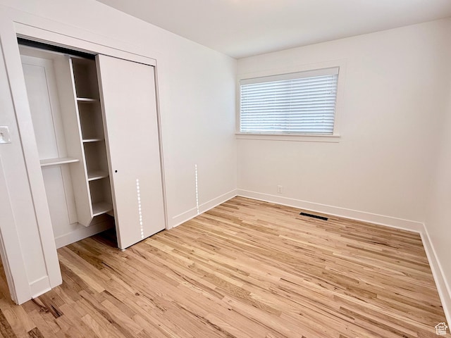 573 E 1600 S, Bountiful, UT 84010 - unfurnished bedroom featuring light wood-style flooring, baseboards, and a closet