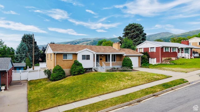 573 E 1600 S, Bountiful, UT 84010 - ranch-style home with covered porch, a mountain view, concrete driveway, brick siding, and a gate