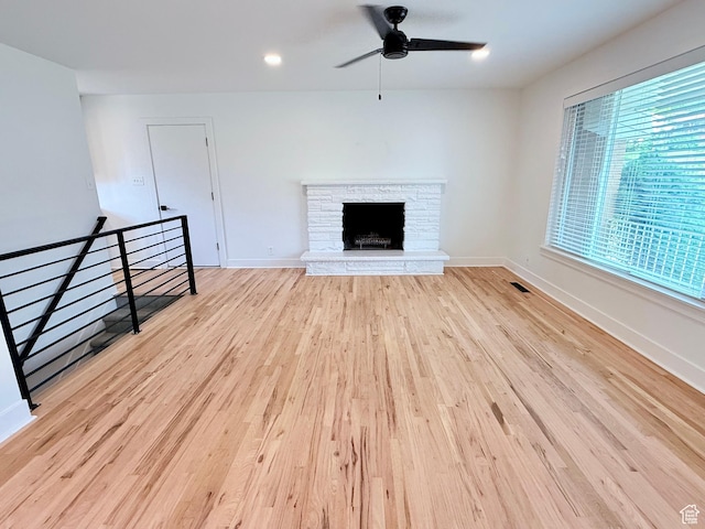 573 E 1600 S, Bountiful, UT 84010 - unfurnished living room featuring a ceiling fan, wood finished floors, a fireplace, baseboards, and recessed lighting