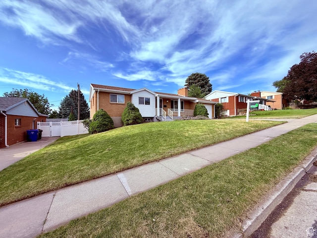 573 E 1600 S, Bountiful, UT 84010 - ranch-style house featuring covered porch, brick siding, a chimney, and driveway