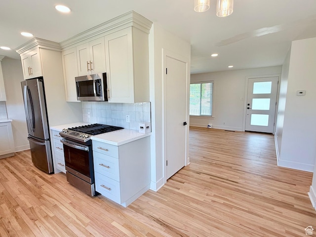 573 E 1600 S, Bountiful, UT 84010 - kitchen with appliances with stainless steel finishes, light wood-type flooring, light countertops, tasteful backsplash, and baseboards