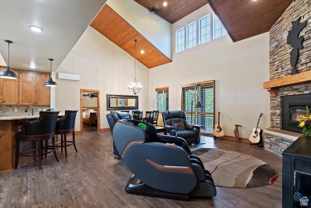 145 N 10450 E, Huntsville, UT 84317 - living room featuring high vaulted ceiling, a stone fireplace, a chandelier, baseboards, and dark wood finished floors