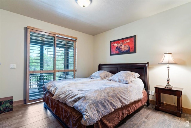 145 N 10450 E, Huntsville, UT 84317 - bedroom with wood finished floors, baseboards, and access to exterior