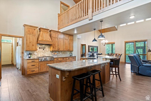 145 N 10450 E, Huntsville, UT 84317 - kitchen featuring a towering ceiling, custom exhaust hood, freestanding refrigerator, stainless steel gas cooktop, and a sink