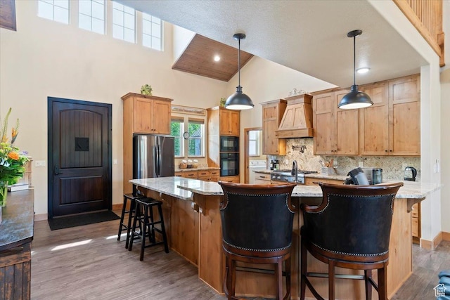 145 N 10450 E, Huntsville, UT 84317 - kitchen featuring premium range hood, high vaulted ceiling, black appliances, backsplash, and wood finished floors
