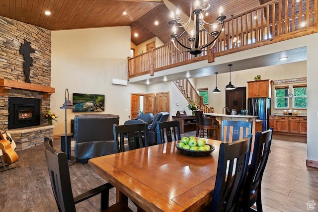 145 N 10450 E, Huntsville, UT 84317 - dining area with light wood-style floors, wood ceiling, high vaulted ceiling, a chandelier, and a fireplace