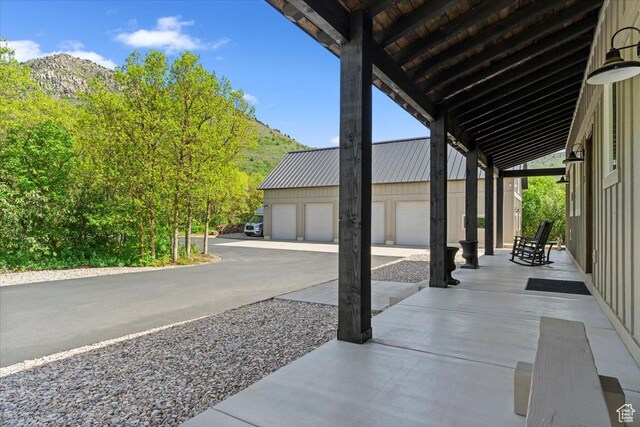 145 N 10450 E, Huntsville, UT 84317 - view of patio featuring a garage, an outbuilding, and a mountain view