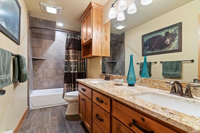 145 N 10450 E, Huntsville, UT 84317 - bathroom with double vanity, shower / tub combo with curtain, toilet, wood finished floors, and baseboards