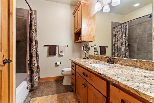 145 N 10450 E, Huntsville, UT 84317 - full bath with vanity, wood finished floors, toilet, shower / bath combination with curtain, and baseboards