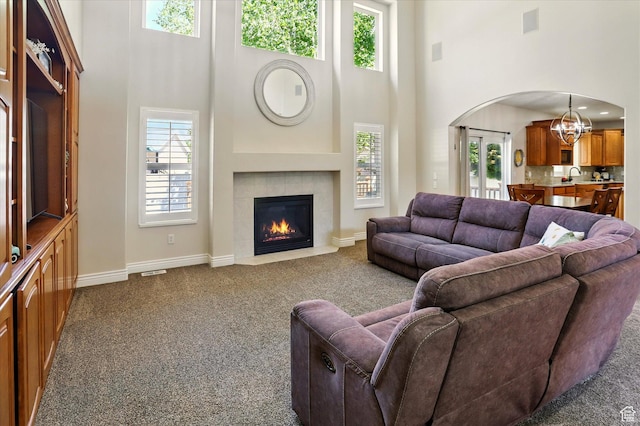 1926 N 1420 W, Provo, UT 84604 - living room with a high ceiling, arched walkways, dark carpet, a chandelier, and baseboards