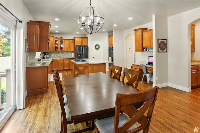1926 N 1420 W, Provo, UT 84604 - dining area featuring arched walkways, light wood-type flooring, a chandelier, recessed lighting, and baseboards