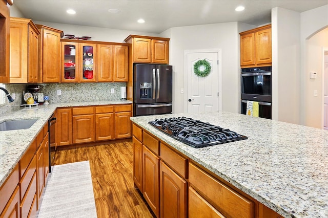 1926 N 1420 W, Provo, UT 84604 - kitchen with refrigerator with ice dispenser, black gas stovetop, a sink, light wood-style floors, and arched walkways