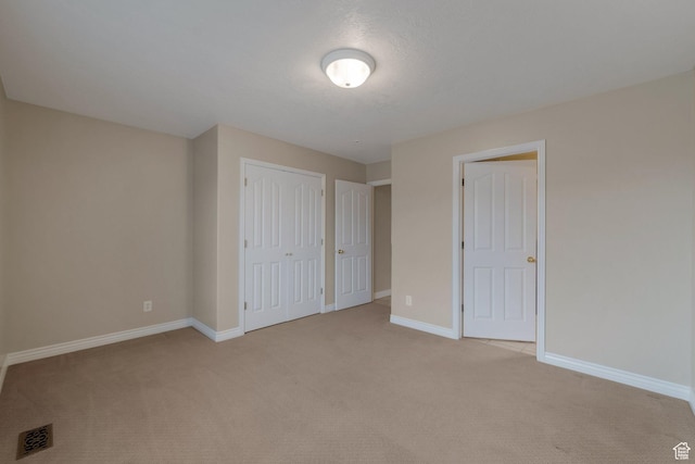 6192 W Ridge Rd, Highland, UT 84003 - unfurnished bedroom featuring light carpet, baseboards, and a closet