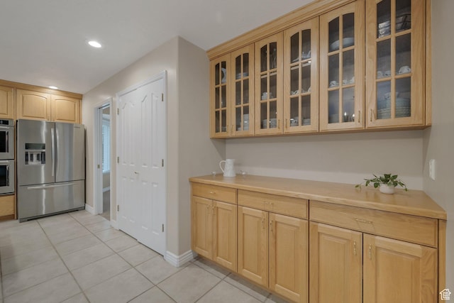 6192 W Ridge Rd, Highland, UT 84003 - kitchen with stainless steel appliances, light tile patterned floors, light countertops, glass insert cabinets, and recessed lighting