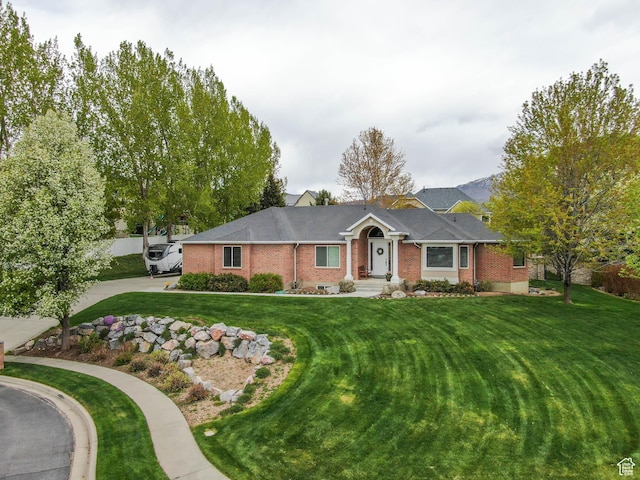 6192 W Ridge Rd, Highland, UT 84003 - ranch-style house with brick siding, a front lawn, and driveway