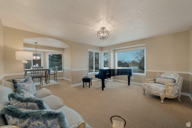6192 W Ridge Rd, Highland, UT 84003 - living room featuring a chandelier, carpet flooring, healthy amount of natural light, a textured ceiling, and baseboards