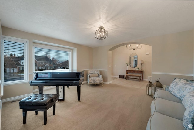 6192 W Ridge Rd, Highland, UT 84003 - sitting room featuring arched walkways, light carpet, a chandelier, and baseboards