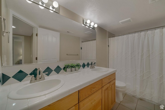 6192 W Ridge Rd, Highland, UT 84003 - bathroom with double vanity, toilet, tile patterned flooring, tasteful backsplash, and a shower with shower curtain