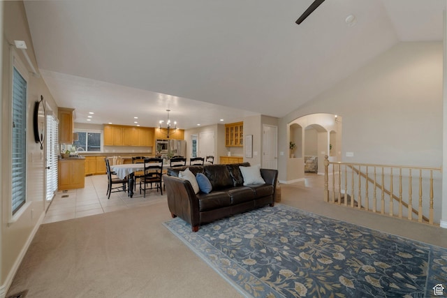 6192 W Ridge Rd, Highland, UT 84003 - living room featuring light colored carpet, recessed lighting, arched walkways, lofted ceiling, and baseboards