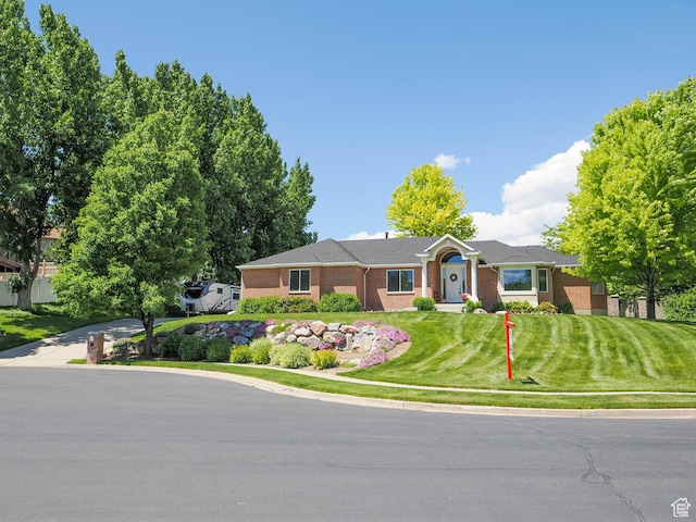6192 W Ridge Rd, Highland, UT 84003 - ranch-style home with a front lawn and brick siding
