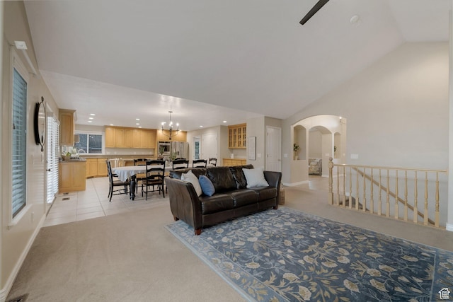 6192 W Ridge Rd, Highland, UT 84003 - living area featuring light colored carpet, recessed lighting, vaulted ceiling, arched walkways, and a chandelier