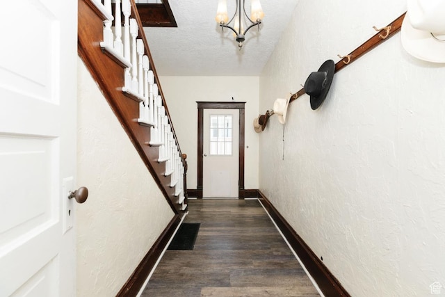 77 N 1st W, Preston, ID 83263 - doorway featuring a textured wall, stairway, baseboards, a chandelier, and dark wood finished floors