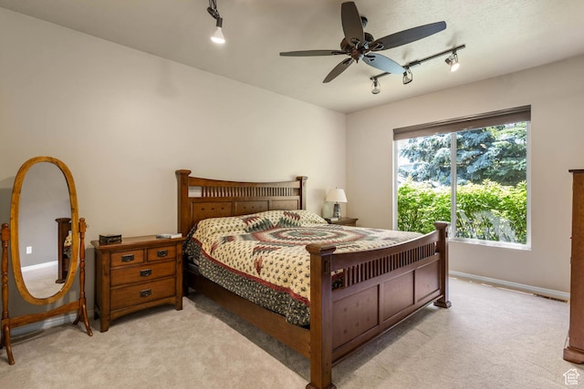 1111 E Bench View Dr, Ogden, UT 84404 - bedroom with rail lighting, light carpet, baseboards, and a ceiling fan