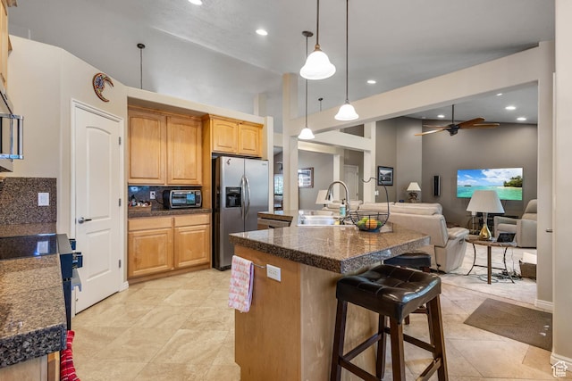1111 E Bench View Dr, Ogden, UT 84404 - kitchen with stainless steel refrigerator with ice dispenser, a sink, a breakfast bar area, open floor plan, and recessed lighting
