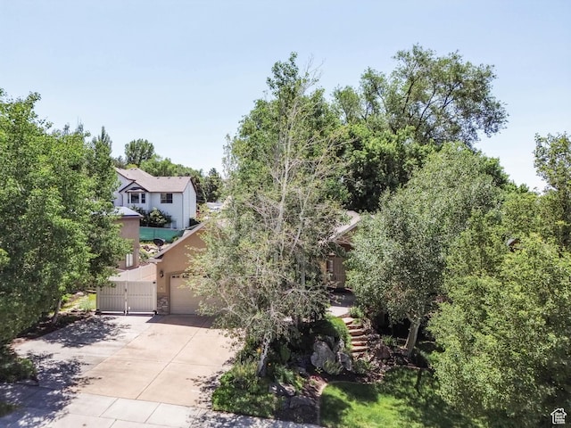 1111 E Bench View Dr, Ogden, UT 84404 - obstructed view of property with concrete driveway, a gate, stucco siding, and stone siding