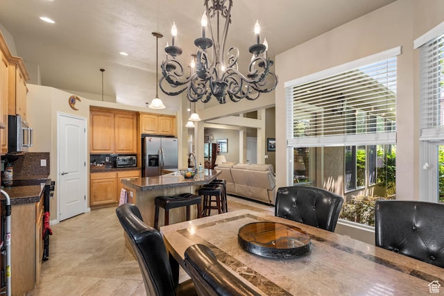 1111 E Bench View Dr, Ogden, UT 84404 - dining room with a high ceiling, a chandelier, and light tile patterned flooring
