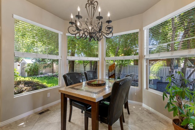 1111 E Bench View Dr, Ogden, UT 84404 - sunroom featuring baseboards, a chandelier, and tile patterned floors