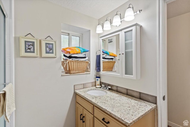 3272 N 175 W, North Ogden, UT 84414 - bathroom featuring vanity and a textured ceiling