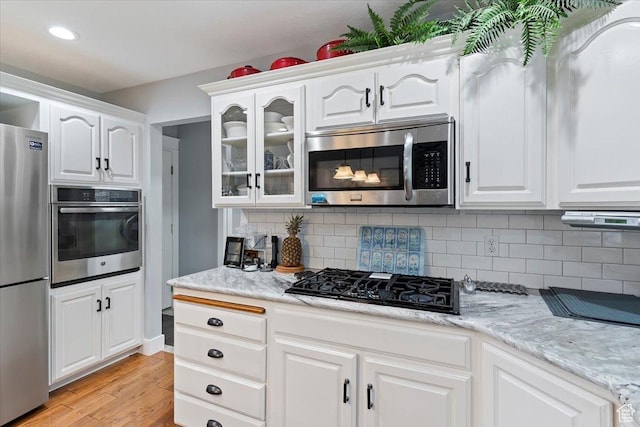 3272 N 175 W, North Ogden, UT 84414 - kitchen featuring stainless steel appliances, light wood finished floors, white cabinetry, glass insert cabinets, and recessed lighting