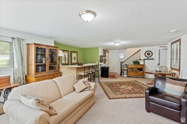 3272 N 175 W, North Ogden, UT 84414 - living room with stairs, a textured ceiling, and light carpet