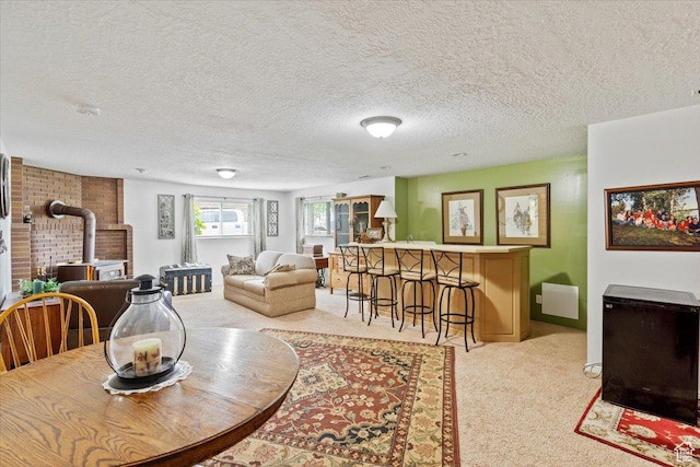3272 N 175 W, North Ogden, UT 84414 - dining room with a wood stove, light colored carpet, a textured ceiling, and baseboards